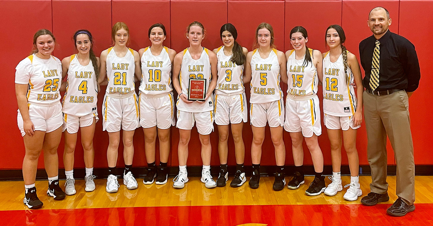 Vienna Lady Eagle basketball team members gather for a group photo with the second-place plaque from the Calvary Lutheran Girls Basketball Tournament Saturday after their 48-31 loss to St. Elizabeth in the championship game. Team members (above, from left) pictured include Marissa Hollis, Jaedyn Schell, Madison Weeks, Kiera Hollis, Kadence George, Aubrey Reeves, Salene George, Jaelee Stricklan, Lakayela Parmeley and head coach Kevin Schwartze. Not pictured was  Brooke Mercer.